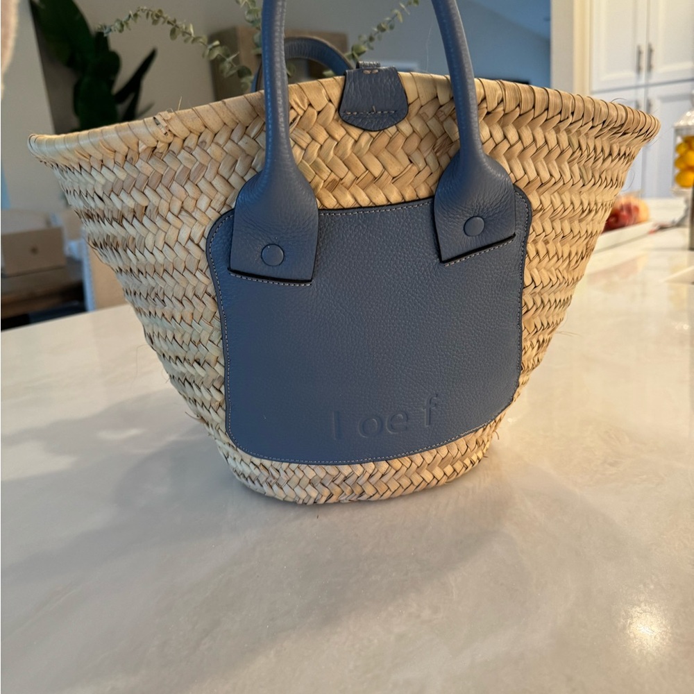 Beautiful handwoven palm leaf bag with textured leather from Italy.